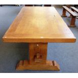 A thick set 20th century oak kitchen table, the cleated plank top on slab end supports,