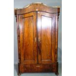 A late 19th century walnut Continental arch top two door armoire on bun feet,