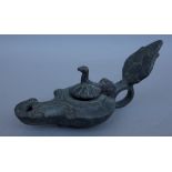 An unusual bronze oil lamp, the hinged lid in the form of a bird, 14cm wide.