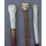 An 18th century and later mounted bamboo walking cane with clenched fist pommel (80cm),