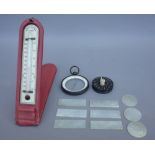 A Negretti and Zambra ivorette thermometer, cased, an unusual compass,