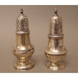 Two silver baluster shaped pepperettes, one base London 1753, the other base London 1769,