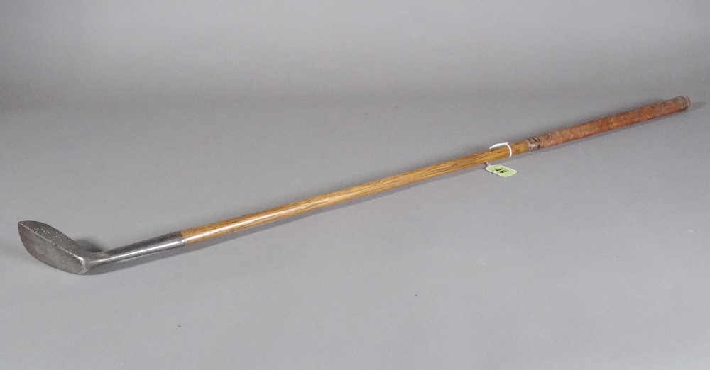 A Harry Vardon 'medium lie' putter with hickory shaft and leather bound grip, 85cm.