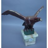 A polychrome painted bronze eagle, circa 1930, signed 'M. Decoux' on an onyx plinth, 35.