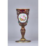 A Bohemian ruby glass enamelled chalice, late 19th century, with foliate painted enamel oval,