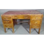 A 20th century mahogany pedestal desk with six short and one long drawer about the knee and faux