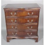 A 20th century mahogany serpentine chest of four long drawers on bracket feet,