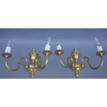 A set of three Louis XVI style gilt bronze twin branch wall lights with fruiting urn finial over a