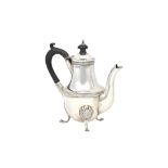 A small silver coffee pot, decorated with reeded bands,