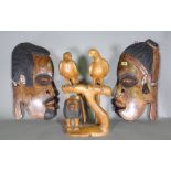 A pair of 20th century hardwood African hanging facial panels,