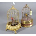 A brass cased musical bird cage and another.