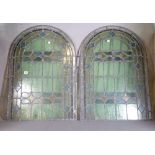 A pair of early 20th century arch top stained glass windows, (2).