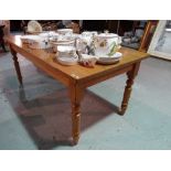 A 20th century pine rectangular dining table on turned supports, 183cm long x 91cm wide.