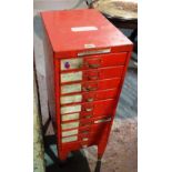 A 20th century red painted metal ten drawer tool chest containing a quantity of tools,