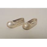 A pair of miniature Japanese white metal shoes bearing Japanese marks.