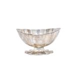 A silver sugar bowl, of panelled shaped oval form, raised on a shaped oval foot, Sheffield 1908,