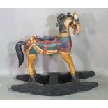 A 20th century child's hardwood rocking horse with painted decoration.