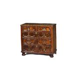 A Charles II walnut two part chest of two short and three long geometric doubled drawers on bun