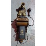 An early 20th century style wall mounted telephone.