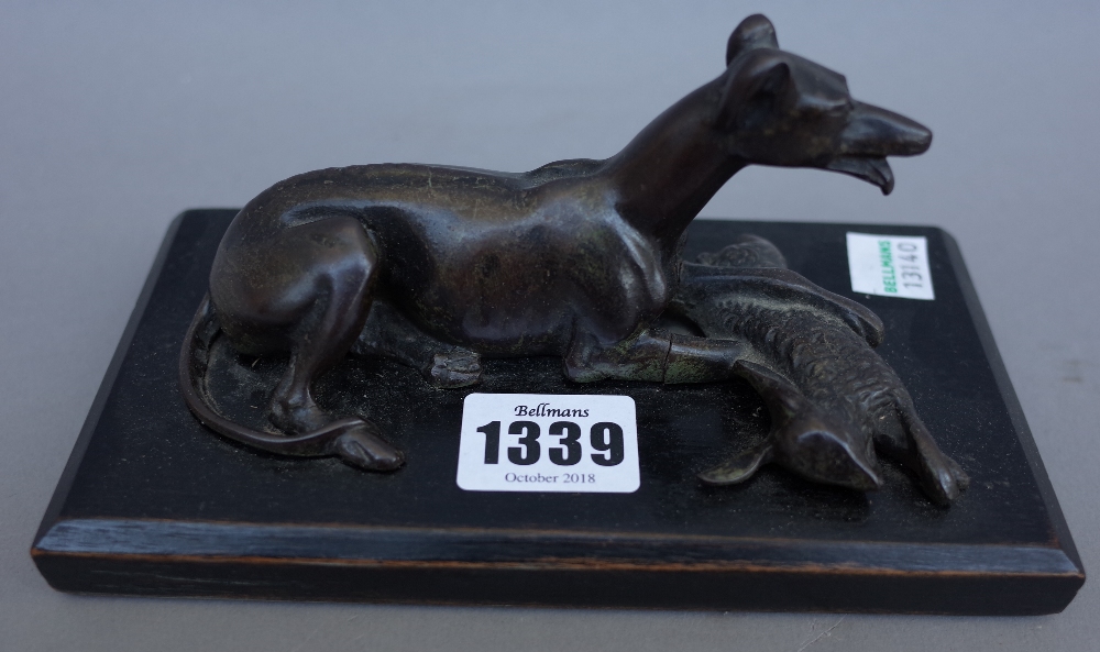 A late 19th century French School bronze figure of a coursing greyhound, recumbent with dead hare,