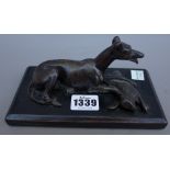 A late 19th century French School bronze figure of a coursing greyhound, recumbent with dead hare,