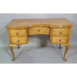 A 20th century Sapele Kenyan dressing table with five drawers about the knee on pad feet,