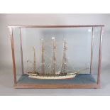 An early 20th century scratch built model of a three masted ship, in a glazed oak box, 59cm wide.