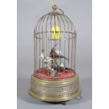 A brass cased musical bird cage.