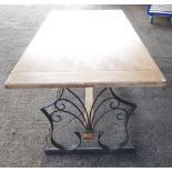 A 20th century dining table, the cleated bleached oak plank top on a wrought iron base,