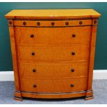 A Biedermeier style part ebonised bird's eye maple bowfront chest of five long drawers,