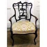 An Edwardian foliate carved mahogany salon elbow chair, with upholstered stuff over seat,