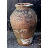 A weathered terra cotta amphora, 90cm hi