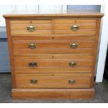 An Edwardian walnut chest of two short a