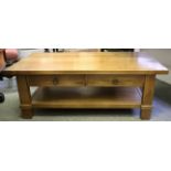 A contemporary hardwood low two tier centre table, with two drawers,