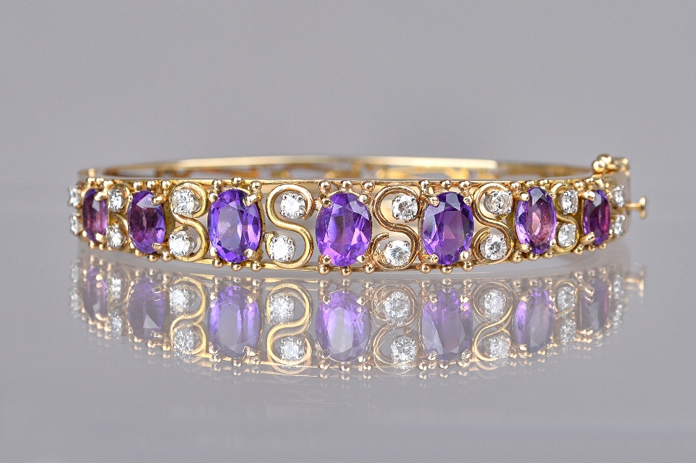 A gold, amethyst and diamond set oval hinged bangle,