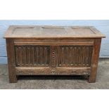 A reproduction late 17th century style oak coffer, of panelled construction, 97cm wide, 42cm deep,