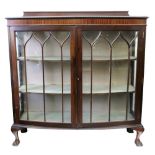 A 'Chippendale Revival' mahogany bowfront dwarf display cabinet, enclosed by glazed doors,