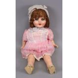 A vintage dressed doll, with sleeping eyes, composition head, hands and legs, 51cm high.