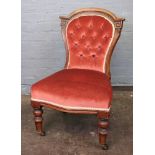 A pair of Victorian carved walnut button down upholstered nursing chairs.