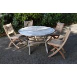 A circular slatted teak garden table, 124cm diameter, 74cm high and four similar folding chairs (5).