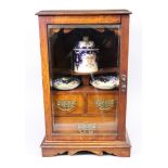 A smoker's Edwardian oak table top cabinet , 29cm wide, 21cm deep, 44cm high.