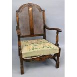 A reproduction late 17th century style armchair, with cane back.