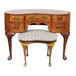 A reproduction early 18th century style walnut and burr walnut veneered kidney shape writing or