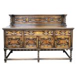 A reproduction oak sideboard, in late 17th century style, geometrically panelled, 184cm wide,
