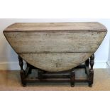 A late 17th century oak gateleg table, the hinged oval top above an end drawer,