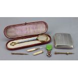 An engine turned silver cigarette case, Birmingham 1934, 3ozs, a foliate engraved toothpick,