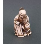 A Japanese ivory netsuke, carved as a sage standing holding a scroll with a boy seated beside, 5.