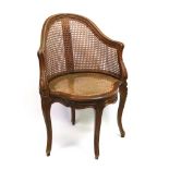 A Louis XV style beech stained as oak bergere corner chair, late 19th century,