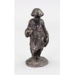 A cast iron figure of a young boy in robes, 12cm high.