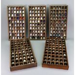 Thimbles in five rectangular display cases, to include Chinese cloisonne, china, metal, glass,